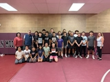 SLVFB employees presenting a We Care, We Share donation to AHS Wrestling Team