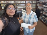 SLVFB employees presenting a We Care, We Share donation to Carnegie Public Library