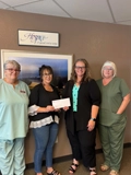 SLVFB employees presenting a We Care, We Share donation to Hospice De Valle