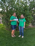 SLVFB employees presenting a We Care, We Share donation to Sanford School