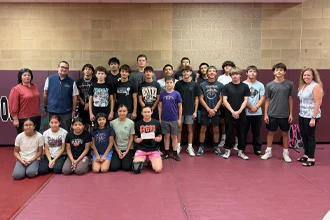 SLVFB employees presenting a We Care, We Share donation to Alamosa High School Wrestling