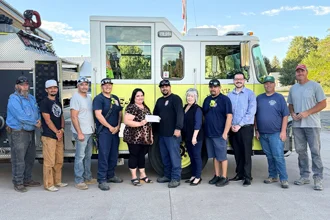 SLVFB employees presenting a We Care, We Share donation to Monte Vista Fire Department