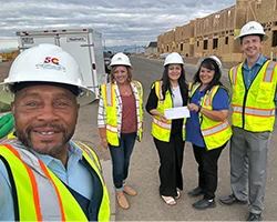 SLVFB employees presenting a We Care, We Share donation