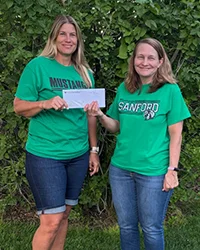 SLVFB employees presenting a We Care, We Share donation